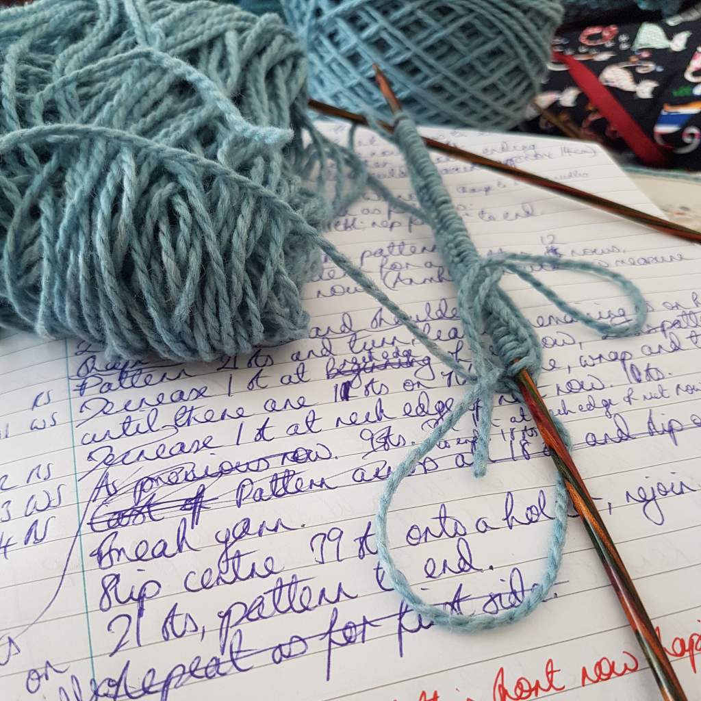Closeup of a design in progress and cast on stitches, by Natalie in Stitches, independent knitting pattern designer.